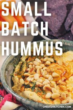 hummus in a bowl with tortilla chips on the side and text overlay that reads, small batch hummus