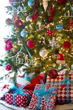 a christmas tree with presents under it