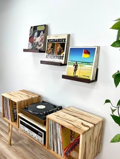 a record player is sitting on a wooden shelf