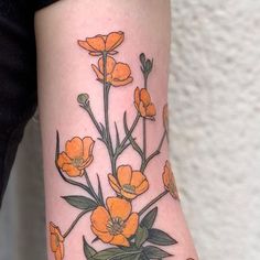 an orange flower tattoo on the arm