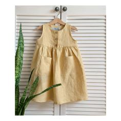 This linen dress is gorgeous and perfect for all seasons and occasions. Made from high quality soft fabric 100% linen. Sleeveless. Avalible sizes (child height ): - EU80 (31,50 inch) 9-12Months - EU86 (33,86 inch) 12-18M - EU92 (36,22 inch) 18-24M - EU98 (38,58 inch) 2-3Years - EU104 (40,94 inch) 3-4Y - EU110 (43,31 inch) 4-5Y - EU116 (45,67 inch) 5-6Y - EU122 (48,03 inch) 6-7Y The item is made to order and it takes about 3-5 days to go and will be shipped immediately when it will be ready. I wi Yellow Casual Linen Dress For Summer, Yellow Cotton Sleeveless Summer Dress, Casual Yellow Linen Dress For Summer, Casual Yellow Linen Summer Dress, Casual Yellow Linen Beach Dress, Yellow Cotton Sleeveless Vacation Dress, Yellow Linen Dress For Spring, Sleeveless Cotton Dress In Flax Color, Summer Yellow Linen Dress