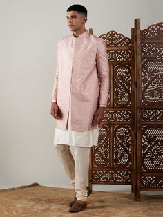 Vastramay Men's Peach Sequined Indo Western Sherwani With Kurta Pyjama Set Make a statement at weddings and festive occasions with this elegant Indo Western Sherwani set from VASTRAMAY. Crafted in a peach hue with sequin detailing, this outfit exudes traditional charm with a modern twist. The set includes a Sherwani and matching Kurta Pyjama. Features: Sequined detailing for a stylish look Modern Indo Western design Includes Sherwani and Kurta Pyjama Perfect for weddings and festive occasions Sp Festive Straight Kurta Bandhgala For Reception, Bandhgala Straight Kurta For Diwali Reception, Diwali Reception Bandhgala Straight Kurta, Pink Kurta For Eid Reception, Traditional Long Sleeve Pink Bandhgala, Traditional Pink Long Sleeve Bandhgala, Formal Pink Kurta With Naqshi Detailing, Pink Kurta For Reception And Transitional Season, Pink Traditional Naqshi Sherwani