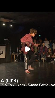 a person on a stage with a skateboard in front of an audience at a dance event