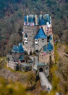 an aerial view of a castle in the mountains