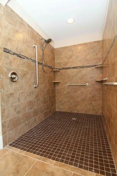 a walk in shower sitting inside of a bathroom next to a tiled floor and walls