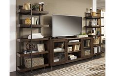 an entertainment center with bookshelves, shelves and a flat screen tv