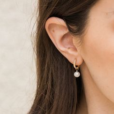 The Pearl Hoop Earrings are endlessly elegant, yet dainty enough to wear every day. A perfect pair of earrings to complete your look and take on your day! You can dress them up or down; whether it's a stroll in the sand or an evening in the city, these luscious hoops are sure to delight. DETAILS 14k gold filled -or- sterling silver 13mm wire & earrings Genuine 6mm freshwater pearls Two-in-one: you can remove the pearls to wear them as plain hoops Comes as a pair Safe for sensitive skin & shower Mini Pearl Earrings, Gold Hoop Pearl Earrings, Earings Minimalism, Pearl Earrings Outfit, Pearl Hoops Earrings, Stacy London, Pearl Earrings Designs, Classic Pearl Earrings, Bridesmaid Gifts Earrings