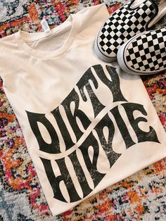 Dirty Hippie Free-spirited Cotton T-shirt With Graphic Print, Trendy White Festival T-shirt, Trendy White T-shirt For Festivals, Free-spirited Cotton Crew Neck T-shirt, White Relaxed Fit T-shirt For Festival, White Hippie Tops With Letter Print, White Hippie Crew Neck T-shirt, White Crew Neck Hippie T-shirt, Hippie Style T-shirt With Letter Print