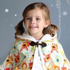 Kinderspel Hooded Cape – Soft Cotton Baby Cape with Stylish Hood and Easy Buckle Closure Keep your baby warm and stylish with the Kinderspel Hooded Cape. Designed to offer comfort and cuteness during chilly days, this cape features a lightweight yet cozy cotton fabric with a silky-soft feel. The adorable patterns and vibrant colors ensure your little one stands out, while the easy buckle closure and shoulder line help keep the cape in place for hassle-free wear. Whether for playtime or outings, Fun Winter Outerwear For Playtime, Playful Cartoon Print Outerwear For Playtime, Playful Outerwear With Cartoon Print For Playtime, Playful Cartoon Print Outerwear, Cute Multicolor Outerwear For Playtime, Winter Clothes For Kids, Spring Toddler, Kids Winter Outfits, Chic Kids