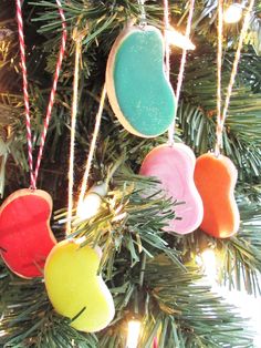 ornaments hanging from a christmas tree with candy in the shape of hearts and an apple