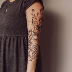 a woman with a flower tattoo on her arm