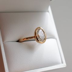 an engagement ring in a box with a diamond on the top and bottom part of it