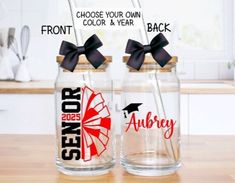 two personalized glass jars with straws in them