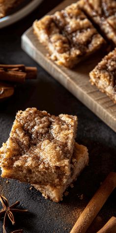 cinnamon sugar bars stacked on top of each other next to cinnamon sticks and anisette