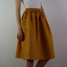 "Write the selected color in the message Handmade mustard linen midi skirt with зatch pockets on the sides, elastic waistband, perfect for casual wear and suitable for any occasion in any season Details: - 100% natural linen produced in Europe ; - medium weight (180 gram per square meter); - color: mustard, could be any from our colors catalog (color samples at the photo); Made to order, approximately a few days, If you have any questions please message me and I will be glad to answer. Size guid Chic Yellow Skirt With Elastic Waistband, Summer Linen Skirt With Side Pockets, Summer Midi Bottoms With Side Pockets, Long Yellow Skirt With Pockets, Yellow Long Skirt With Pockets, Yellow Skirt With Elastic Waistband For Day Out, Summer Day Out Skirt With Side Pockets, Yellow Skirt With Pockets For Spring, Chic Summer Skirt With Side Pockets