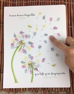 a hand is pointing at a dandelion card