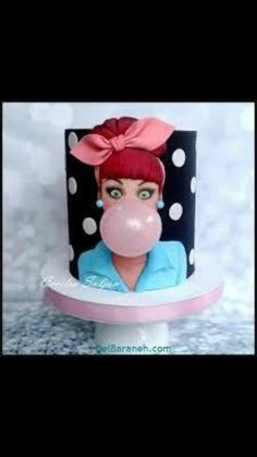 a cake with a woman's face and bubble gum in the shape of a balloon