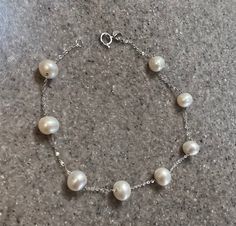 "BEAUTIFUL EFFY 14K WHITE GOLD PEARL BRACELET THE BRACELET IS CLEARLY MARKED 14K AND EFFY ON THE END. IT WEIGHS APPROXIMATELY 2.6 GRAMS AND MEASURES 7.5\" LONG. THIS LOVELY BRACELET FEATURES 8 BEAUTIFUL ROUND PEARLS.  THIS IS IN VERY NICE CONDITION AND GOOD WORKING ORDER!  WHAT A SPECTACULAR GIFT FOR THAT SPECIAL LADY!! WILL SHIP IN A GIFT BOX  STOCK # S540 As with all jewelers, I do enlarge pictures of the jewelry.  This is to your advantage, so you can see all details more clearly.  I do provide measurements of the jewelry, so be sure to review it to better understand the true size of the item. Please consider the measurements carefully.  I recommend grabbing a ruler or tape measure and visualizing the item." White Pearl Bracelet For Formal Occasions, White Pearl Bracelet For Formal Events, Formal White Gold Bracelets With Pearl Chain, Formal White Gold Bracelet With Pearl Drop, White Pearl Bracelet With 17 Jewels, White Gold Round Bracelet With Pearl Charm, White Gold Bracelet With Pearl Charm, White Gold Round Bracelets With Pearl Charm, White Gold Bracelets With Pearl Chain