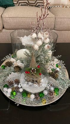 a glass plate with christmas decorations on it and a small tree in the centerpiece