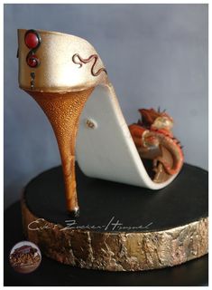 a close up of a shoe on top of a wooden stand with other items in the background