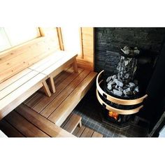 a wooden bench sitting next to a fire place