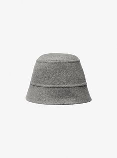 This bucket hat from our Fall/Winter 2024 collection is exquisitely tailored from structured wool melton with a substantial brim. Take a cue from the runway and pair it with matching knitwear and tailored separates for a look that reads relaxed yet refined. Curved Brim Winter Hat For Work, Chic Winter Workwear Hats, Wool Bucket Hat With Curved Brim For Fall, Chic Wool Cloche Hat For Winter, Winter Wool Cloche Hat With Flat Brim, Classic Felt Bucket Hat For Winter, Luxury Wool Felt Hat For Winter, Chic Wool Cloche Hat, Chic Winter Bucket Hat With Curved Brim