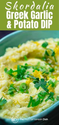 a bowl filled with green garnish and potato dip