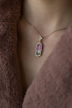 What a treat for the eyes! Wowza Watermelon Tourmaline Framed with Brilliant Diamonds is an extravagant pendant that contains one incredible natural watermelon tourmaline of 4.75 carats held by claw prongs in a regal shaped frame of brilliant white diamonds. The 18" diamond cut cable chain completes this look. 14k White gold 4.75ct Tourmaline .37ctw VS/F natural diamond accents Tourmaline White Gold Jewelry With Prong Setting, White Gold Tourmaline Jewelry With Prong Setting, White Gold Tourmaline Ring With Prong Setting, Luxury Tourmaline Pendant Jewelry, Luxury Tourmaline Jewelry With Prong Setting, Watermelon Jewelry, Watermelon Tourmaline Necklace, Faberge Jewelry, Tourmaline Pendant