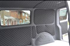 the interior of a vehicle with no one in it, and there is a rear view mirror