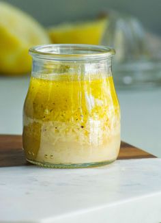 a jar filled with yellow liquid sitting on top of a counter