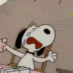 a cartoon dog sitting at a table with a box in front of him and an open mouth