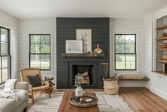 a living room filled with furniture and a fire place in the middle of a room