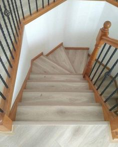 the stairs are made of wood and have black railings