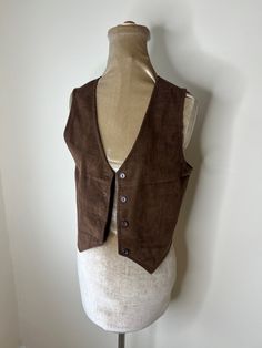 70's brown corduroy waistcoat from C & A. UK 8 UK Size 8. Please check measurements: Chest - 86cm Waist - 80cm Length - 45cm Brown Cotton Vest For Fall, Classic Brown Cotton Vest, Retro Brown Cotton Vest, Retro Brown Vest For Workwear, Retro Brown Vest For Work, Vintage Brown Sleeveless Outerwear, Vintage Brown Cotton Vest, Corduroy Waistcoat, Brown Corduroy