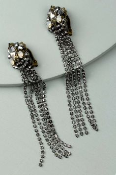 Classic details with a rockstar edge, the Axia Clip-On Statement Earrings feature large petal tassels and amazing beaded adornments. Materials: Crystal Size: 4" x 0.5" Clip-On Backing Luxury Black Statement Clip-on Earrings, Luxury Silver Clip-on Statement Earrings, Luxury Statement Clip-on Earrings, Luxury Jeweled Statement Clip-on Earrings, Luxury Clip-on Statement Earrings, Luxury Plated Statement Clip-on Earrings, Luxury Statement Clip-on Earrings For Formal Events, Luxury Statement Metal Clip-on Earrings, Luxury Tarnish-resistant Statement Clip-on Earrings