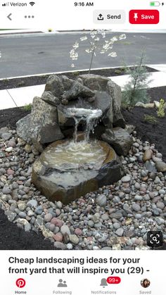 a small waterfall in the middle of a rock garden area with gravel and rocks around it