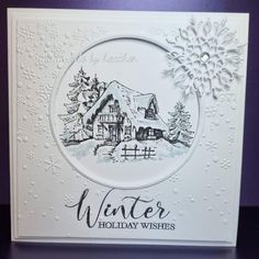 a white card with an image of a house and snowflakes on the front