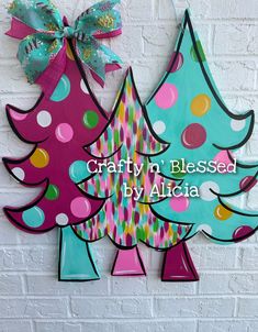 two wooden christmas trees with polka dots on them and the words crafty in blessing by alicia