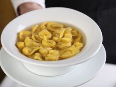 a white bowl filled with macaroni and cheese on top of a saucer