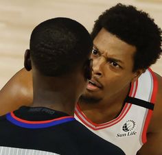 two basketball players are talking to each other