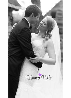 a bride and groom embracing each other in black and white