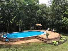 an above ground swimming pool surrounded by trees