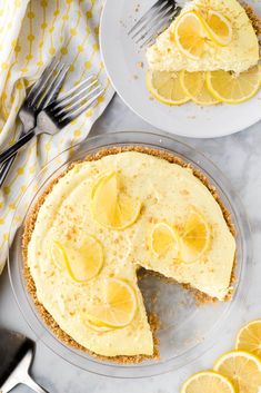 two slices of lemon pie on plates with forks