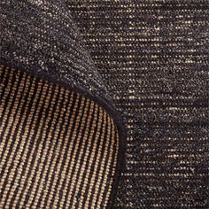 close up view of the fabric on a piece of furniture with brown and black stripes