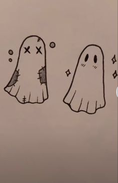 two ghost like objects with crosses on them