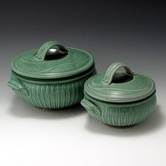 two green ceramic covered dishes with lids