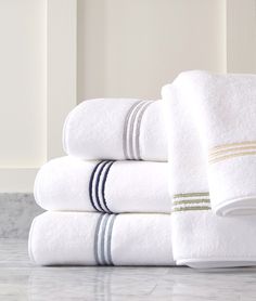 a stack of white towels sitting on top of a counter