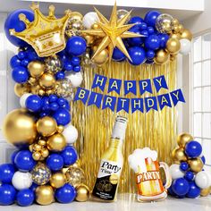 a happy birthday balloon arch with blue, gold and white balloons