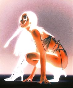 a woman with white hair and high heels kneeling down in front of a light background