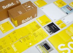 some yellow and white brochures sitting on top of a table